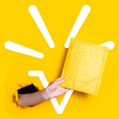 A hand bursting through a wall holding an envelope